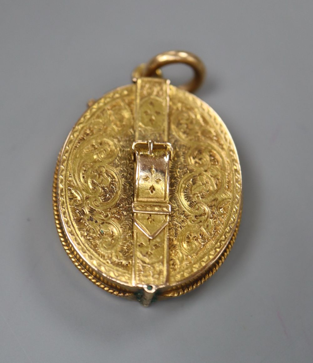 A Victorian engraved yellow metal oval locket , with belt and buckle motif, 26mm, gross 10.4 grams (a.f.),